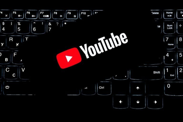 YouTube logo displayed on a backlit keyboard, representing digital media and online content creation.